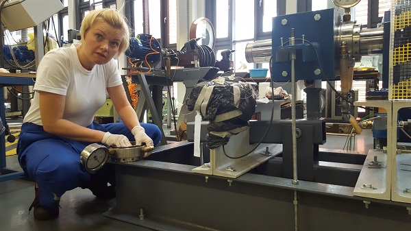 Blond woman working on equipment. Test rig for real scale sliding bearings preparation in the Gdansk University of Technology Faculty of Ocean Engineering and Ship Technology (Poland) laboratory. Photographer: Wojciech Litwin XS